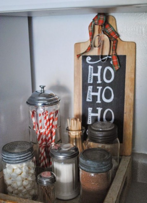 a simple hot cocoa bar with jars and a chalkboard sign