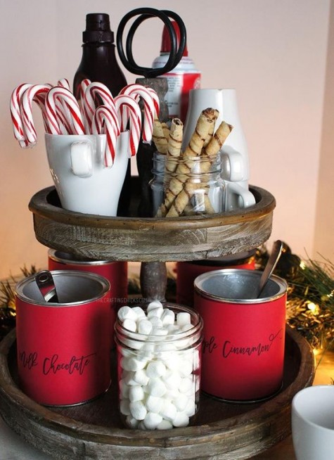a wooden stand with red mugs and various yummies