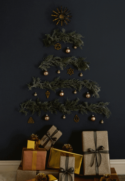 evergreen branches on the wall, lights and Christmas ornaments