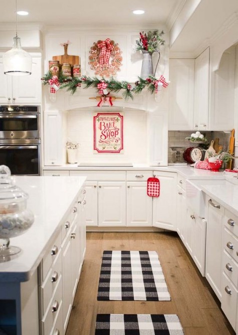evergreen garland with plaid bows and a gingerbread wreath over the shelf
