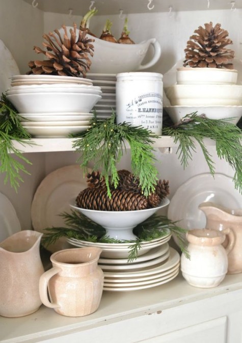 large pinecones and evergreens in the cupboard