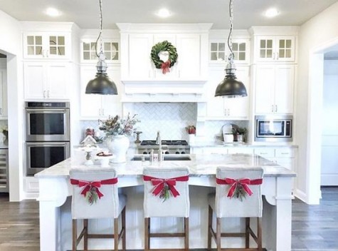 red ribbons and evergreens on the chair backs
