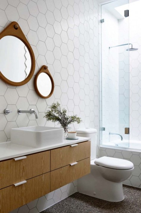 white hex tiles with black grout cover the walls for an interestign look