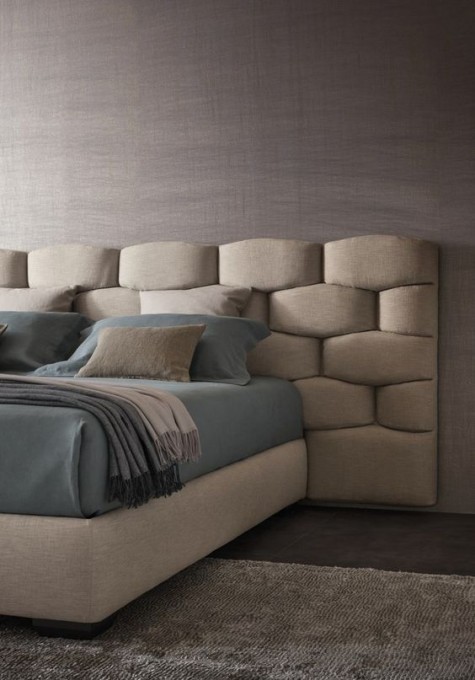 a creative textural padded headboard that takes some space around