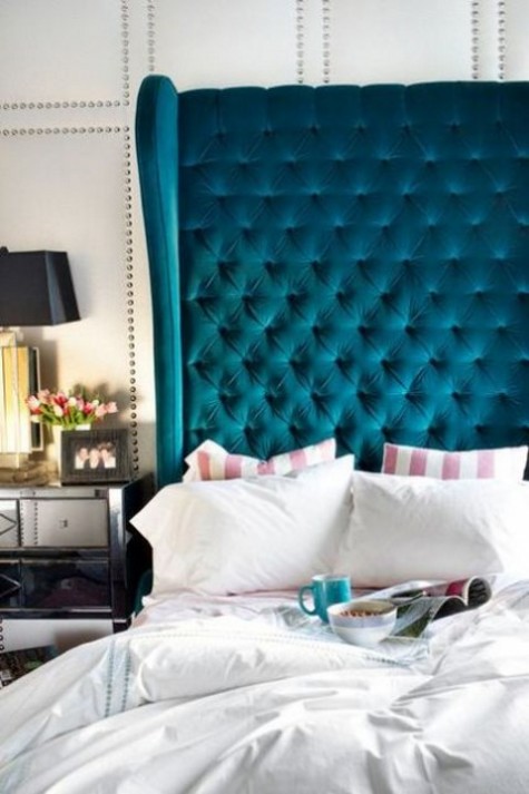 a dramatic teal wingback diamond upholstery headboard