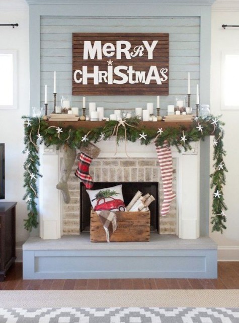 a pallet sign, an evergreen and starfish garland and lots of candles