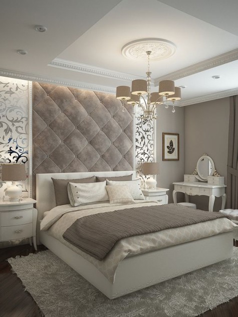 a refined grey velvet tall headboard is an accent in this space