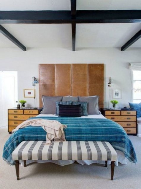 a tall brown leather headboard of several parts