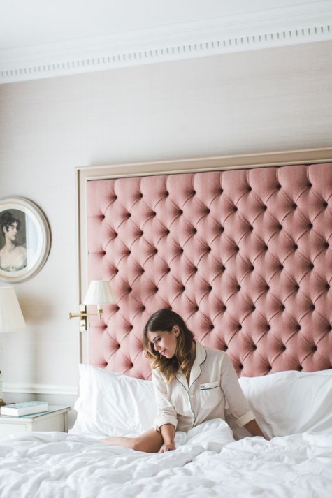 a tall framed pink diamond upholstery headboard