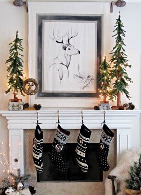 black and whiet stockings, lit up evergreen trees and pinecones on the mantel