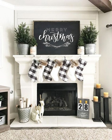 evergreen trees, a chalkboard sign and plaid stockings