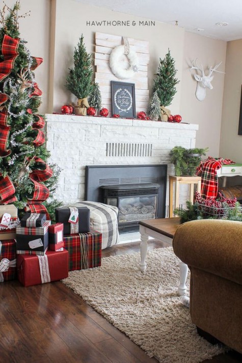 red ornaments, evergrene trees, a white wreath and a chalkboard sign