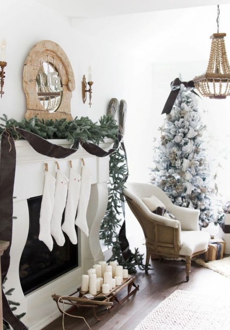 white stockings, an evergreen garland, a vintage wooden frame mirror