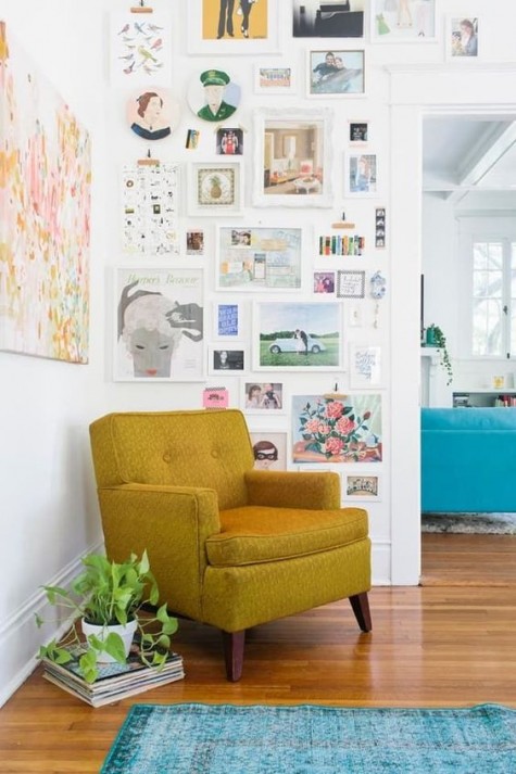 a bold art wall with a colorful chair for an awkward corner