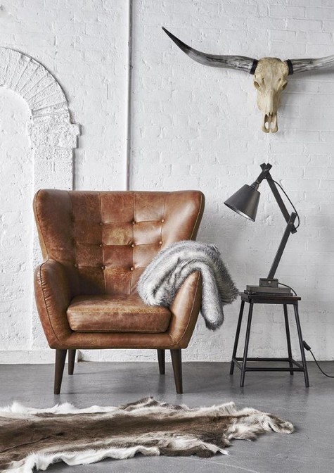 a brown leather chair with vintage lines