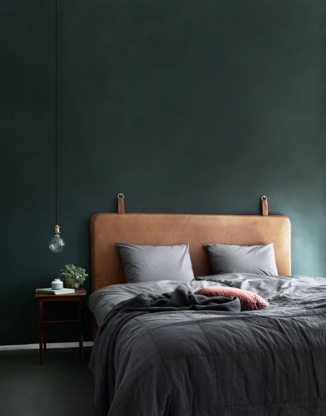 a brown leather upholsrered bed looks very chic
