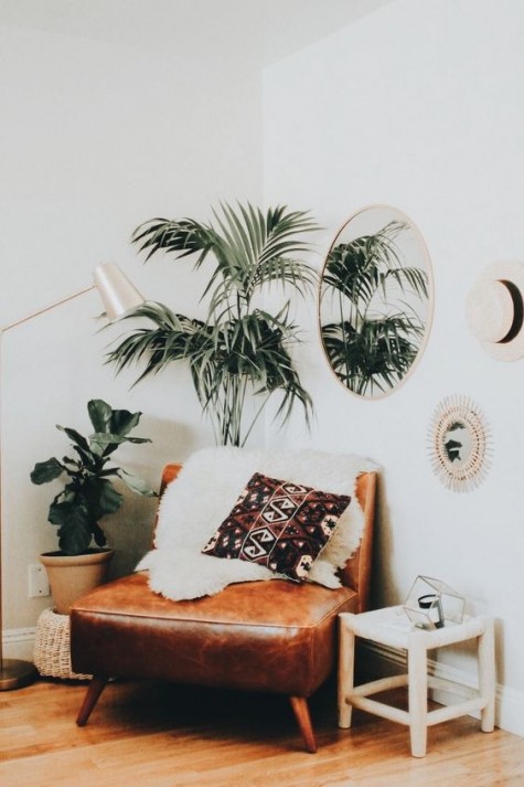 a comfy brown leather chair with a faux fur cover for a boho feel