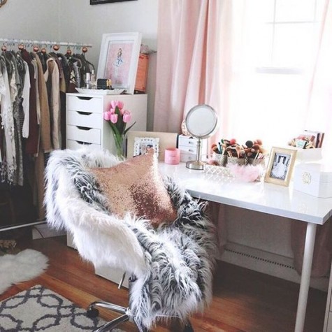 a comfy makeup nook by the window with mirrors, lots of brushes and a comfy faux fur chair