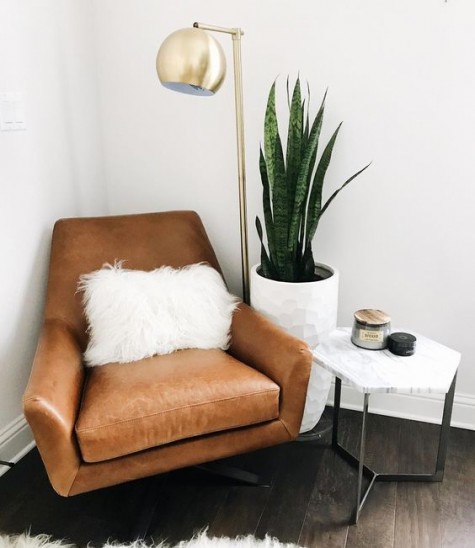a geometric leather chair with a faux fur pillow