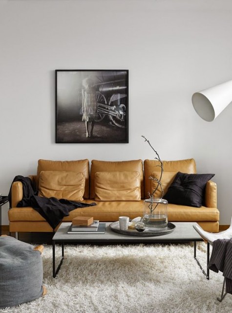 a light brown leather sofa with black touches