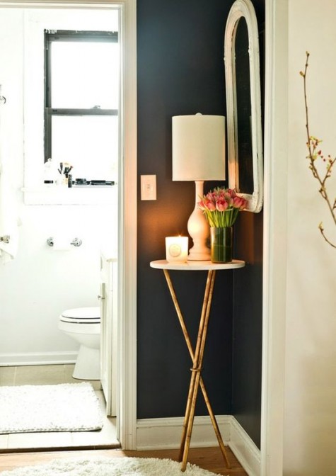 a small elegant side table to place a candle, a lamp and some blooms