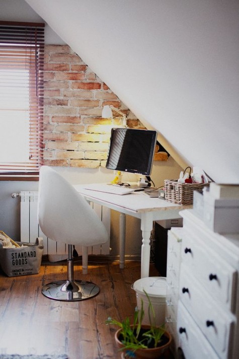 a small workspace with a vintage desk and a modern egg-shaped chair