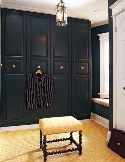 a stylish art deco hack with black molded doors and gold knobs