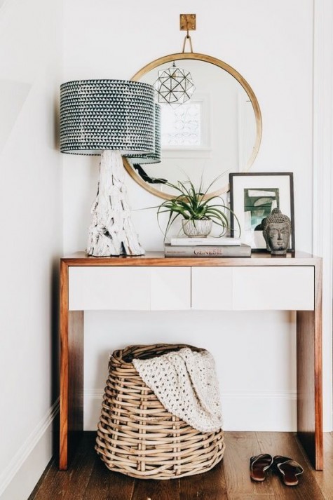 a stylish console table, a basket, a lamp with a driftwood base and some decor