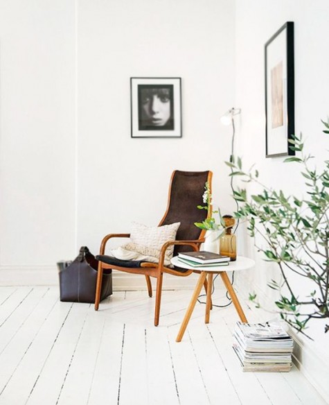 a stylish nook with a chair, a side table and some artworks