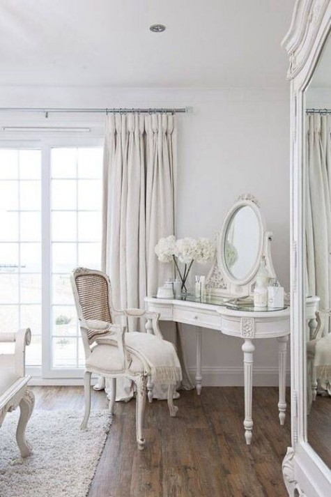 a vintage-style makeup nook with a refined vnaity, mirror and a matching chair