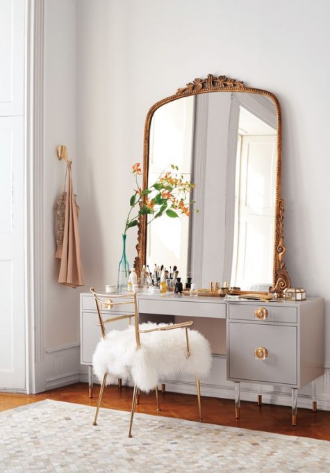 a vintage-styled makeup nook with an exquisite mirror, a large vanity and a faux fur chair