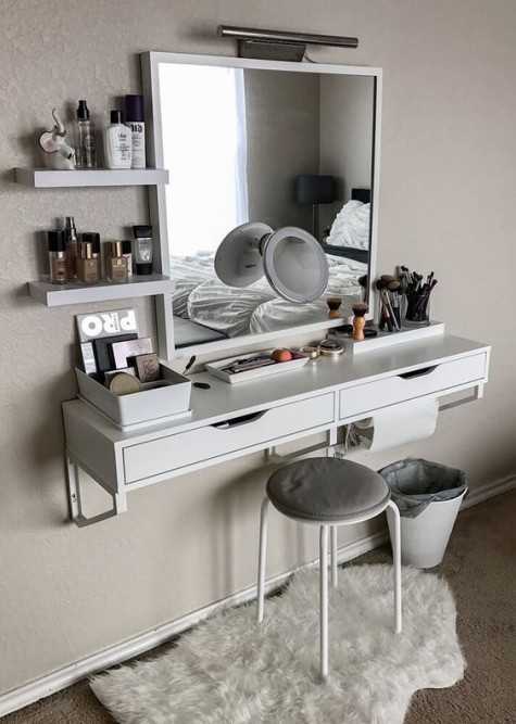 a wall-mounted vanity, a matching mirror, a stool and some floating shelves