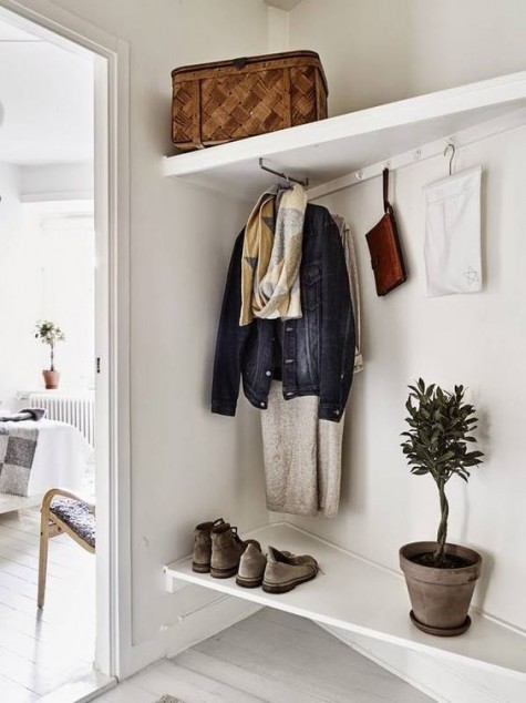 an awkward nook with storage shelves and a coat rack