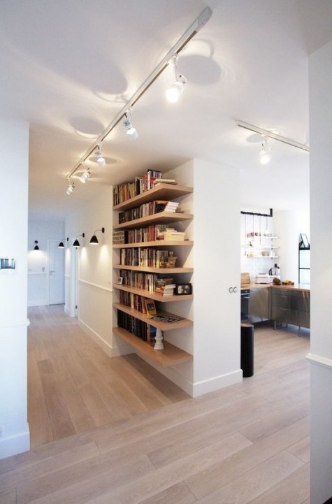 floating shelves in the entryway to keep all the books at hand