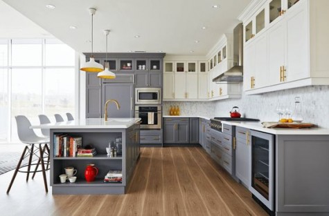 grey and off-white cabinets with a marble tile backsplash and brass touches