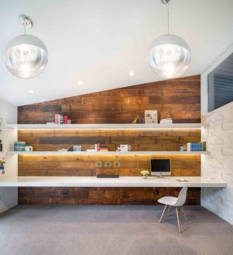 lit-up floating shelves and a larger floating desk