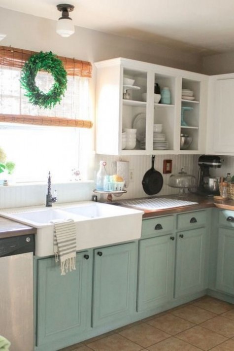 mint and white cabinets, natural wood touches and a wreath for a farmhouse feel