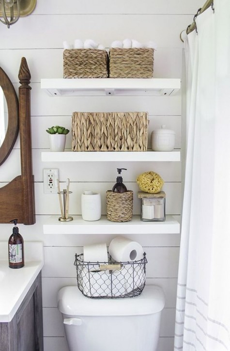 white floating shelves over the toilet to use every inch of space