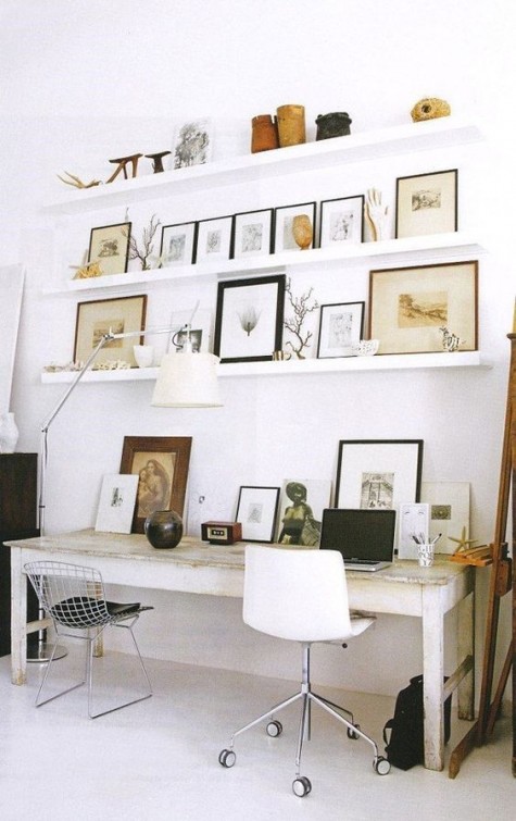 a gorgeous gallery wall with various artworks done with IKEA Ribba ledges