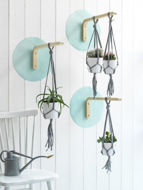 IKEA Frosta stools attached to the wall to hang some planters