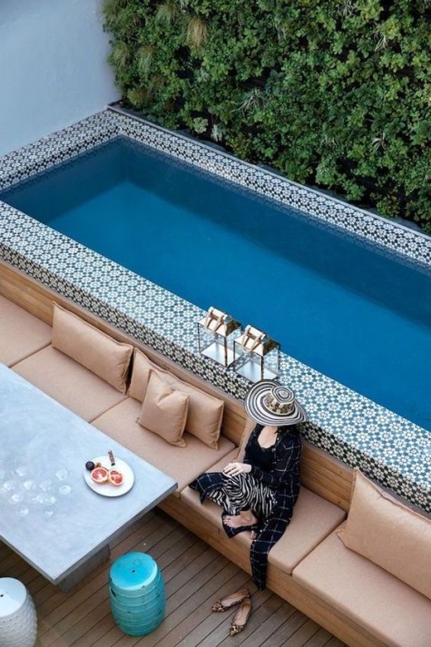 a bold patio with a narrow pool clad with Moroccan-styled tiles