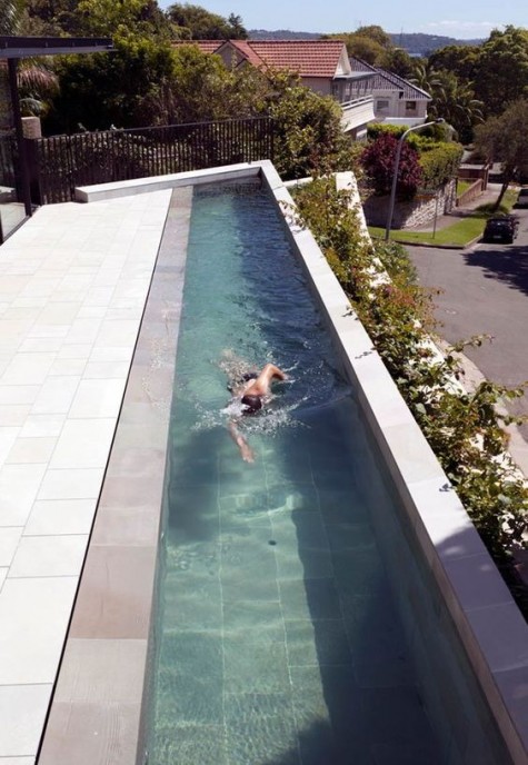 a long narrow pool clad with light-colored tiles for refreshing