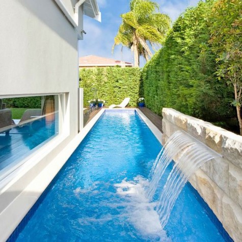 a long narrow pool placed next to the house itself
