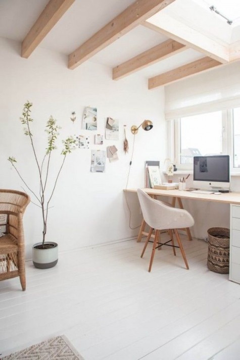 a potted plant and touches of wicker and wood add a summer feel to this airy space