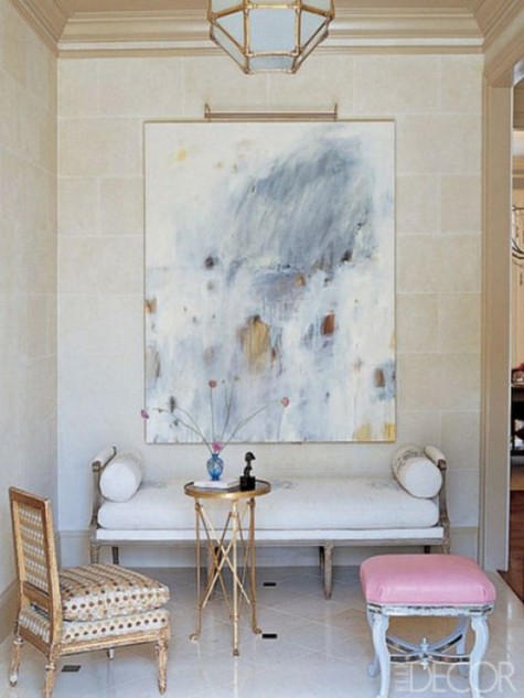 a small refined living room or foyer with an oversized artwork