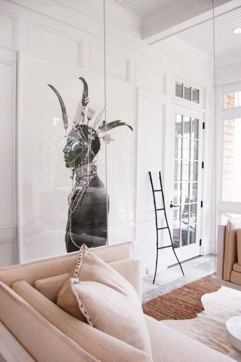 a small sunroom with an oversized artwork that influences the space