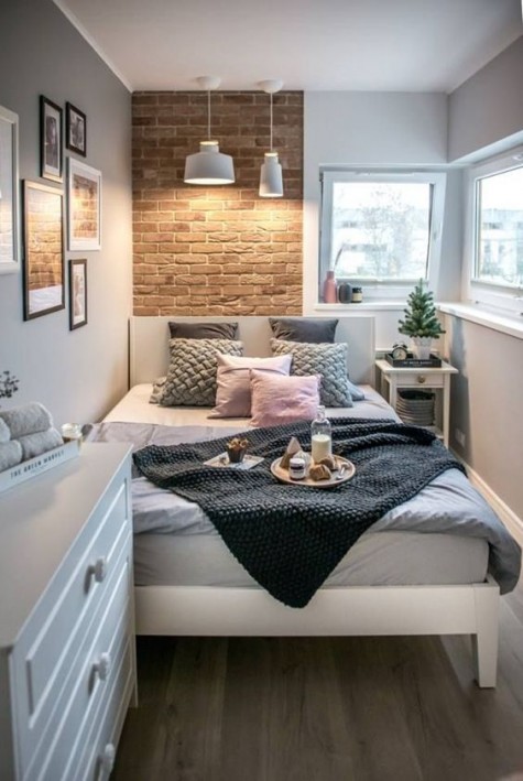 a tiny bedroom with a large scale bed, which is comfy for sleeping