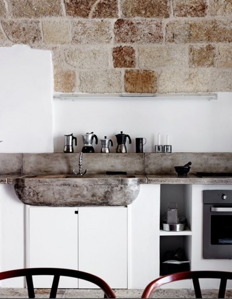masonry and a concrete backsplash and countertops echo and make the space cozier