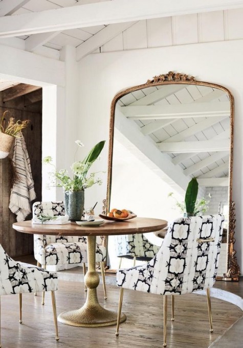 spruce up your dining room with an oversized mirror in a refined frame