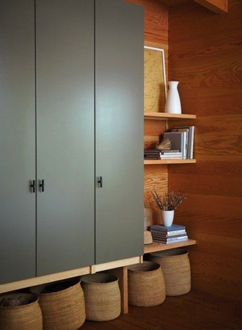 IKEA Pax wardrobe in olive green, mounted on the wall and with open shelving